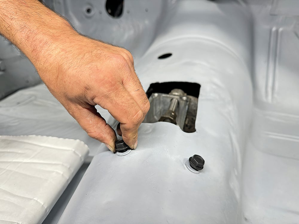 006 Technician installing fasteners in the Camaros interior to secure components copy