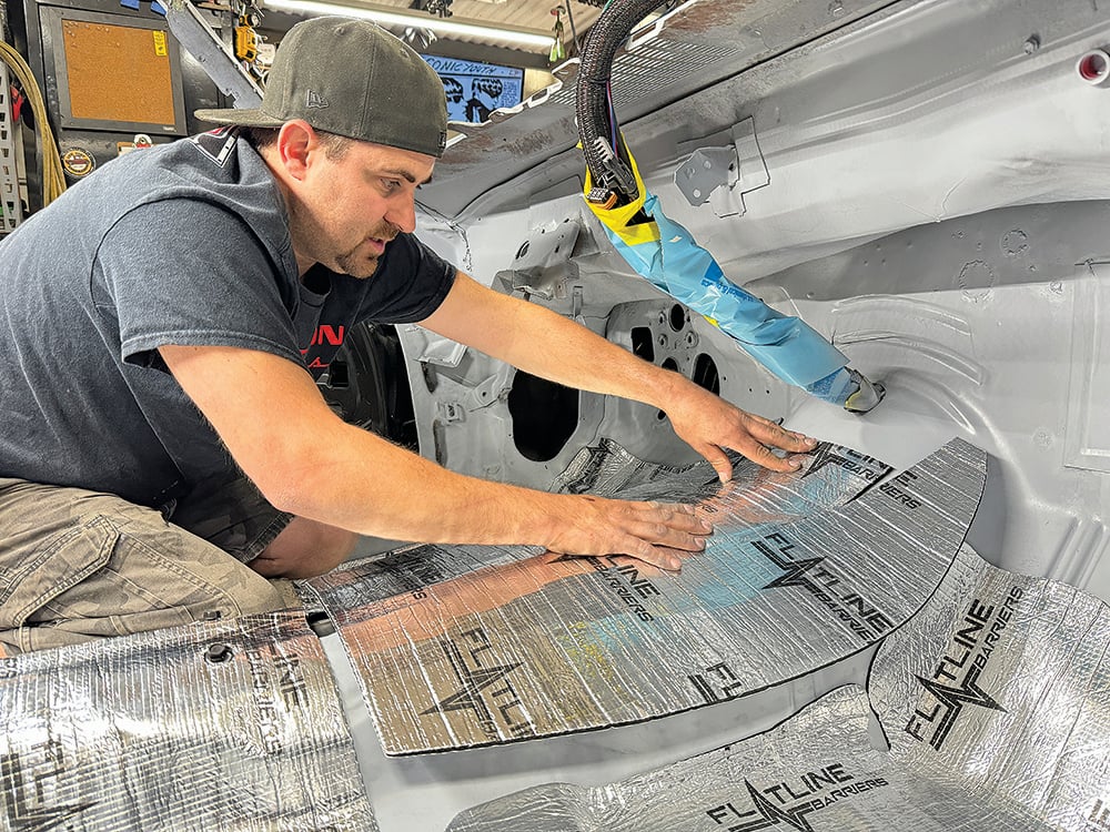 019 Technician applying insulation to the Camaros interior kick panel area copy