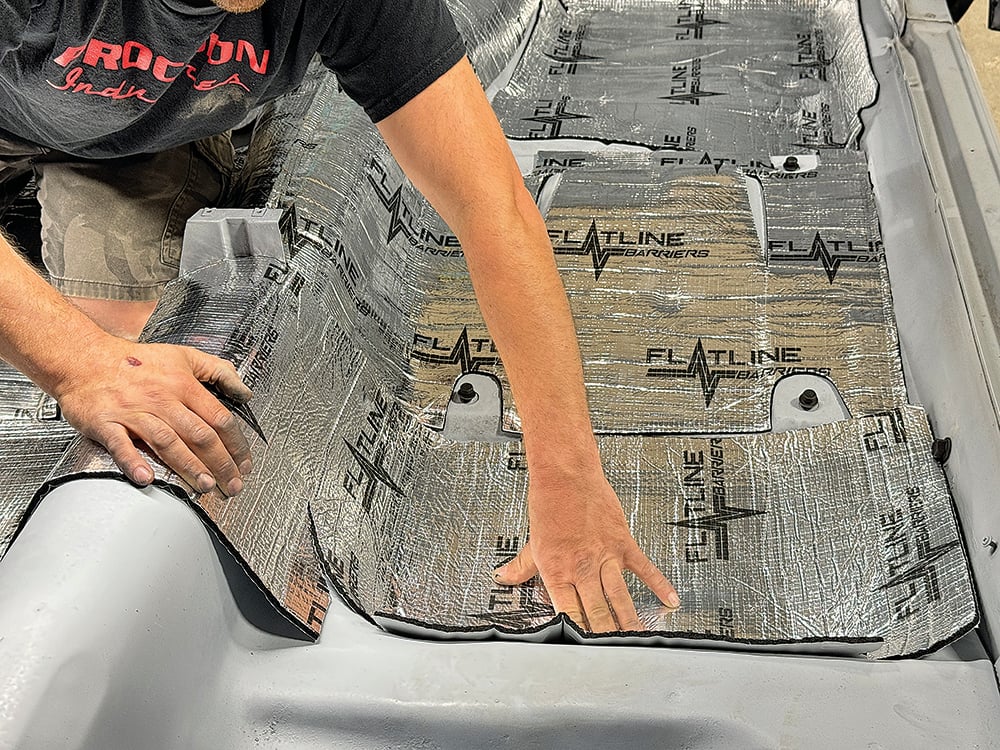 022 Technician pressing insulation into the contours of the rear seat area copy