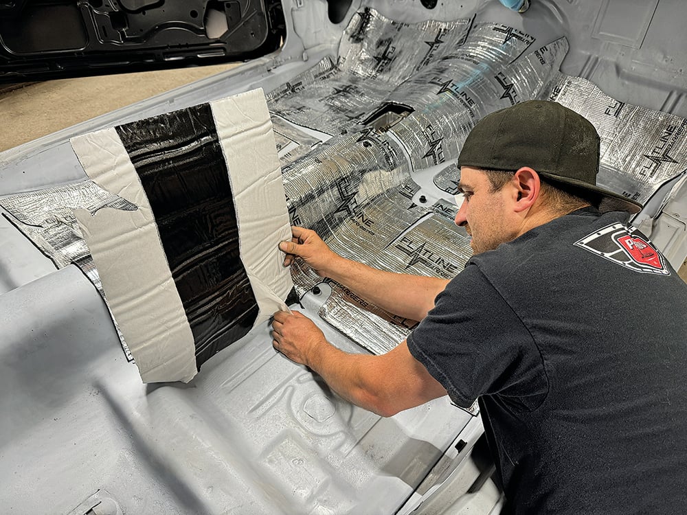 023 Applying black underlay to the Camaros floor for added soundproofing copy