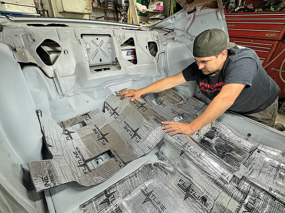 024 Technician fitting insulation panels to the Camaro’s rear interior copy